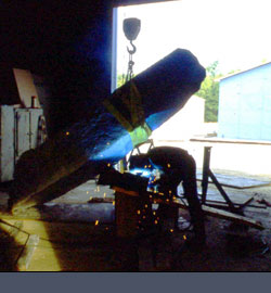 Artist welding during construction at Luck Stone facilities
